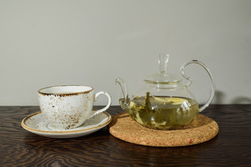 Glass teapot with ginger tea in a cozy coffee shop