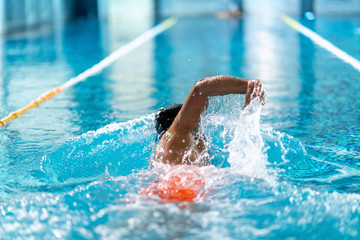 professional swimmer doing exercise in indoor swimming pool - 306664057
