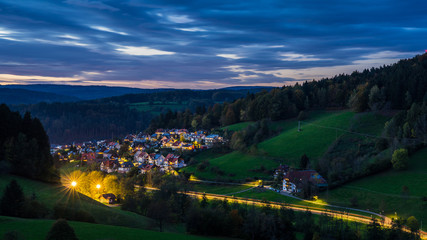 Germany, XXL panorama of beautiful black forest village elzach houses and streets illuminated by...