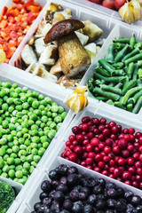 frozen vegetables, fruits and berries in the shop window