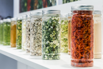 freeze dried vegetables sliced in glass jars in a shop window - 306666037