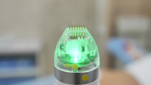 Close-up. Microneedle RF lifting device. Hardware cosmetology. Medical equipment beckground.