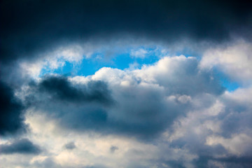 Winter blue sky with clouds over the horizon.
