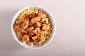 Chicken fillet with gravy over bulgur