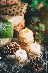 Merry Christmas and happy New year. Candle and Christmas toys on a wooden table. Bokeh. Selective focus.