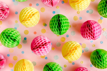 Balloons and confetti on pink background.  Birthday, holiday concept. Flat lay, top view. Birthday party background