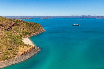 An luxury expedition cruise ship at anchor near Naturalist Island in Prince Frederick Harbor on the remote North West Coast of the Kimberley Region of Western Australia.