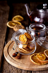 Glass Jars of Dried Citrus and Berry for Tea Ingredients for Tasty Hot Beverage Wooden Tray Wooden Background Dried Oranges Horizontal Copy Space