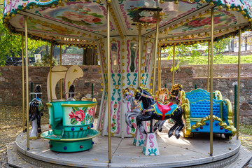 Old small carousel, child playing park