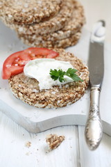 Crispbread with curd cheese on a white background