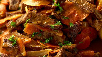 Classic beef stroganoff servei with boiled baby potato and sweet peas