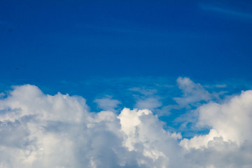Naklejka na ściany i meble White clouds on the blue sky background