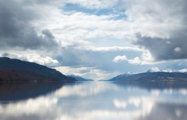 Fototapeta na wymiar A view across Loch Ness looking down the length of the lake, with dark clouds above, in Scotland, UK