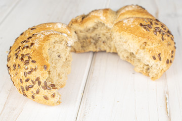 Group of two halves of sesame kaiser roll on white wood