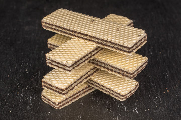 Group of six whole sweet chocolate biscuit wafer on grey stone