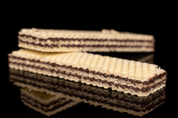 Group of two whole sweet chocolate biscuit wafer isolated on black glass