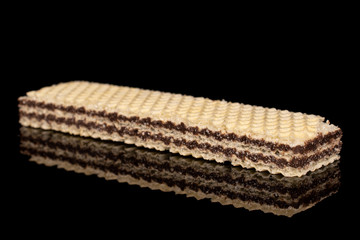 One whole sweet chocolate biscuit wafer isolated on black glass