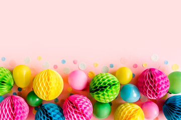 Balloons and confetti on pink background.  Birthday, holiday concept. Flat lay, top view. Birthday party background