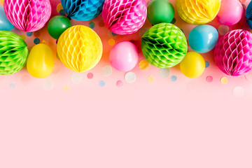 Balloons and confetti on pink background.  Birthday, holiday concept. Flat lay, top view. Birthday party background