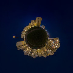 Fototapeta premium Little planet transformation of spherical panorama 360 degrees. Spherical abstract aerial night view multi-storey buildings. Curvature of space.