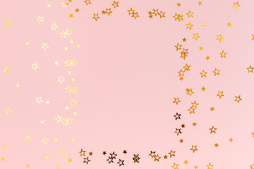 Photo frame mock up with space for text, golden confetti on a pink background. Colorful celebration, birthday background.Christmas or New Year pattern. Flat lay, top view 