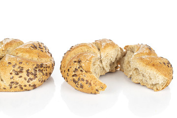 Group of one whole two halves of sesame kaiser roll isolated on white background