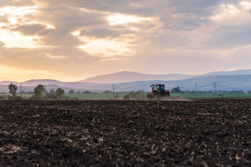 Tractor plowing fields.