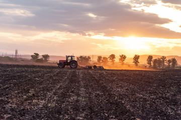 Fototapeta premium Tractor plowing fields.