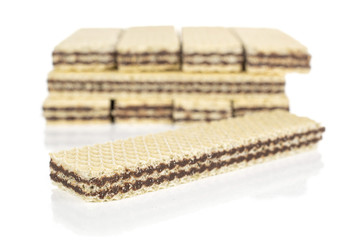 Lot of whole sweet chocolate biscuit wafer one in focus isolated on white background