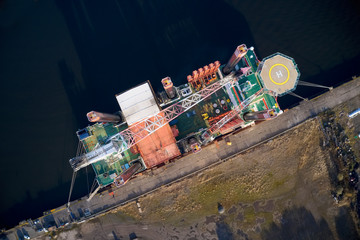 Barge ship crane construction at dock harbour in the sea ocean aerial view from above of...