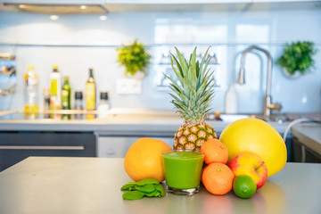 Different tropical fruits and smoothie on home kitchen background, healthy eating lifestyle concept