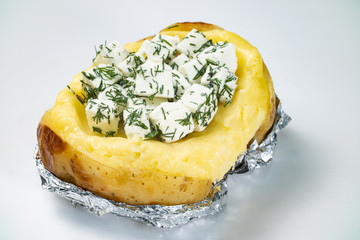 Baked potato with feta cheese filling on white background