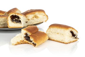 Lot of whole disordered sweet czech bun on gray ceramic plate isolated on white background