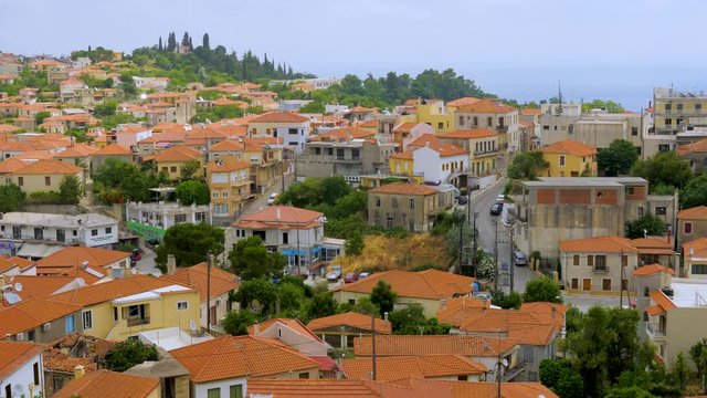 Travel concept. European view of the city, town. Panorama of old city of Kymi, Greece. Houses with red roofs, cityscape of Greek town, village, Greece. Evia Euboea island, Greece. Top view