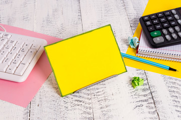 Notepaper stand on buffer wire in between computer keyboard and math sheets