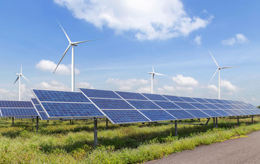 solar cells or solar panels or photovoltaic cells with wind turbines generating electricity alternative renewable wind energy and sunlight energy in hybrid power plant station with blue sky 