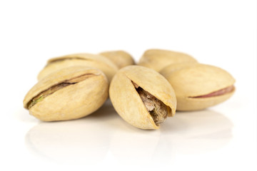 Obraz premium Group of six whole salted pistachio isolated on white background