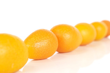 Lot of whole tasty orange kumquat diagonal isolated on white background