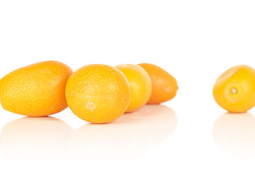 Group of five whole tasty orange kumquat isolated on white background