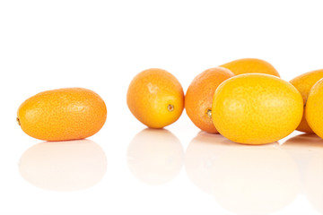 Lot of whole tasty orange kumquat isolated on white background