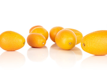 Lot of whole tasty orange kumquat isolated on white background
