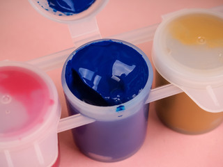 colorful bottle with gouache paints closeup. three bottles of gouache paint close-up, open