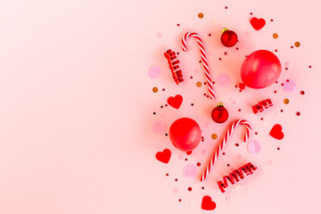 Confetti, balloons, streamers and decoration on a pink background. Colorful celebration, birthday background.Christmas or New Year pattern. Flat lay, top view 