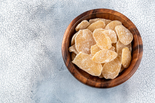 Sweet and Spicy Candied Ginger in a Bowl on light background