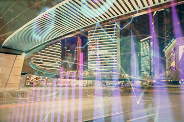 Forex chart on cityscape with tall buildings background multi exposure. Financial research concept.