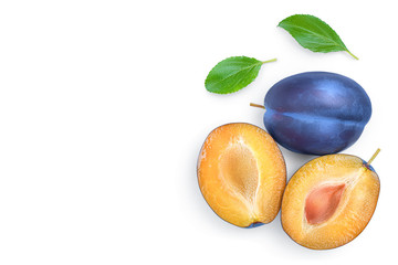 Fototapeta premium fresh blue plum and half with leaves isolated on white background with copy space for your text. Top view. Flat lay