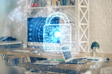 Double exposure of desktop with computer and lock icon hologram. Concept of data safety.