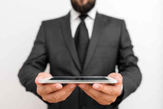 Male human wear formal work suit hold smart hi tech smartphone use hands