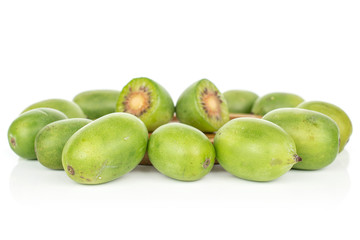 Group of lot of whole two halves of hardy green kiwi isolated on white background