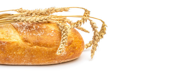 Loaf of bread with ears of wheat on white. Space for text.
